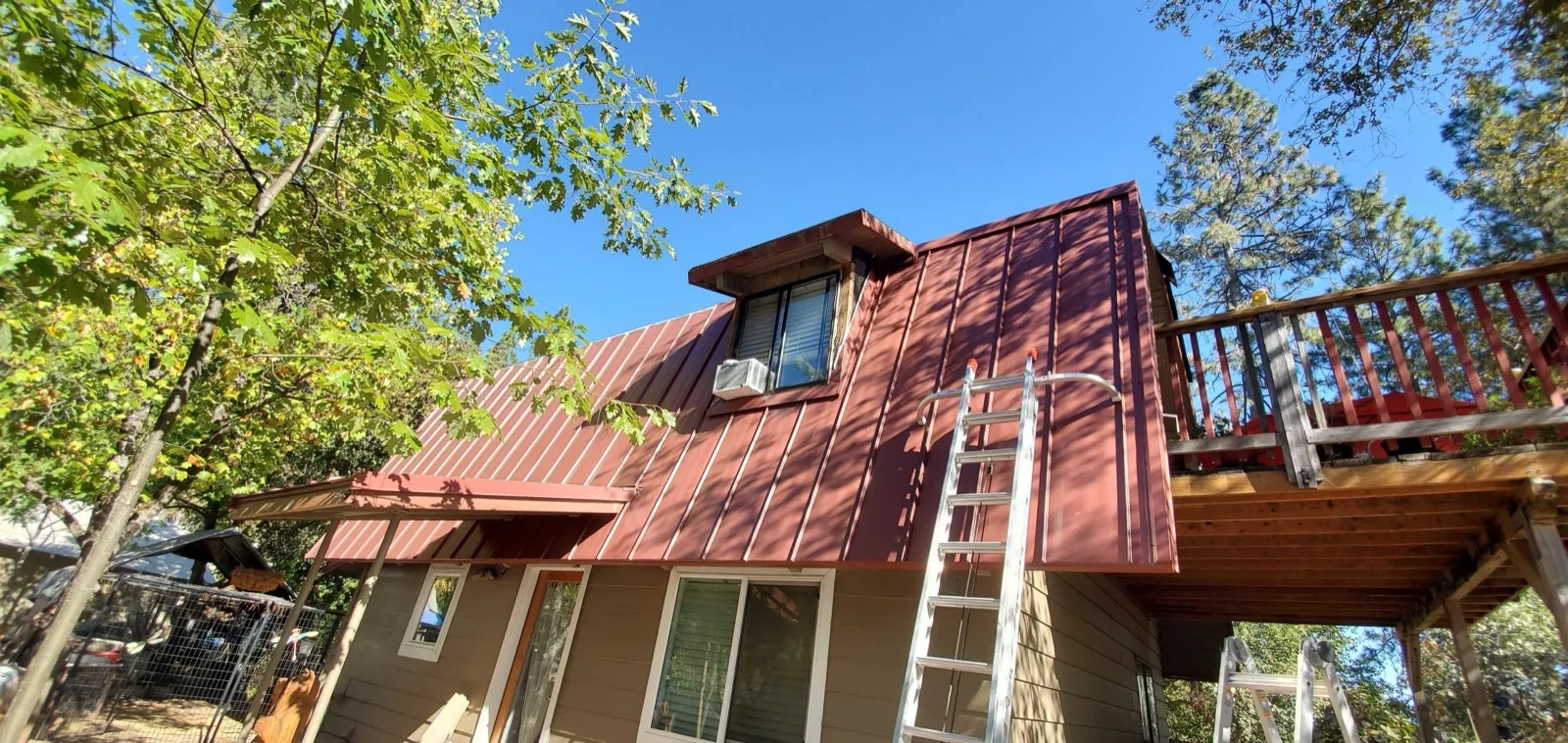 Red standing seam metal roof on a home