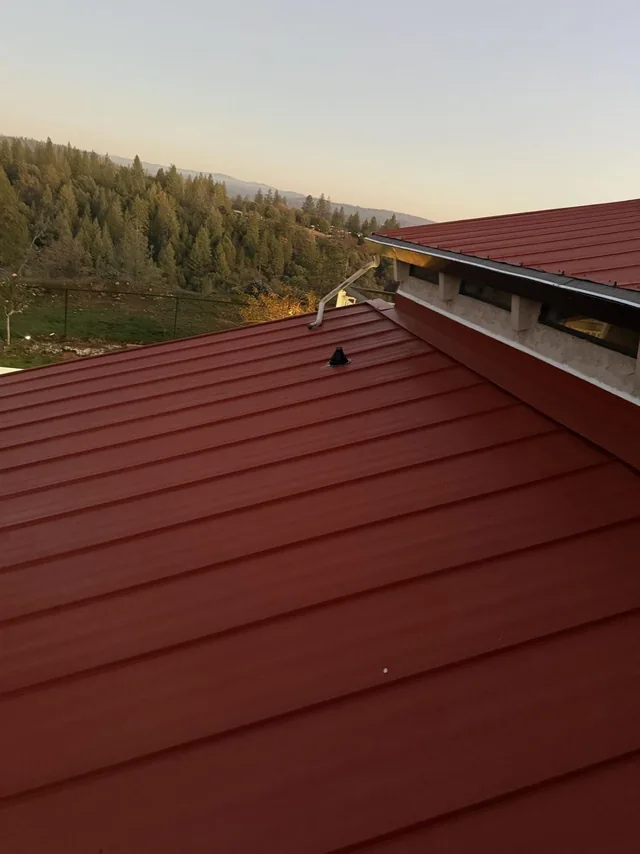 Red standing seam panels and roof edge detail