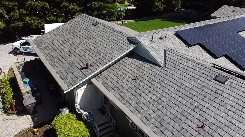 Synthetic slate roofing job with a Spartan truck in the driveway